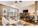 Bright living room features contemporary furnishings and a large window at 1379 Charles Dr # 4, Longmont, CO 80503