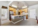 Spacious kitchen featuring stainless steel appliances, a large island and ample cabinet space at 1379 Charles Dr # 6, Longmont, CO 80503