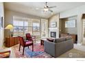 Bright living room with a fireplace, large windows offering natural light, and comfortable seating at 1379 Charles Dr # 6, Longmont, CO 80503