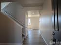 View of the entryway with wood floors, coat closet, and staircase leading up to the second floor at 16815 Mckay Dr, Mead, CO 80542