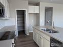 Bright kitchen featuring stainless appliances, island with sink, and walk-in pantry for ample storage at 16815 Mckay Dr, Mead, CO 80542