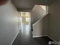 Inviting entryway showcasing hardwood floors and a staircase leading to the upper level at 16835 Mckay Dr, Mead, CO 80542