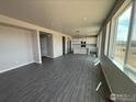 Spacious living room featuring wood floors and expansive windows offering abundant natural light at 16835 Mckay Dr, Mead, CO 80542