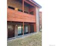 Close-up view of the condo building with brown doors and windows at 1961 Centennial Dr, Louisville, CO 80027