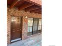 Exterior view of the condo with a brown front door and sliding glass door at 1961 Centennial Dr, Louisville, CO 80027