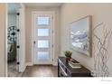 Inviting entryway with wood floors, a modern door, and elegant decor at 2962 Newfound Lake Rd, Berthoud, CO 80513