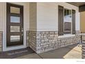 Stylish front door with decorative stone accents and a welcoming entrance mat at 2962 Newfound Lake Rd, Berthoud, CO 80513