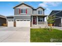 Attractive two-story home with a three-car garage, manicured lawn, and a charming front porch at 298 Chardon Ave, Brighton, CO 80601