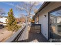 Open-air balcony with wood railing, offering an outdoor space for relaxation at 3275 34Th St # 77, Boulder, CO 80301
