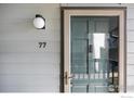 Welcoming front entrance with a secure glass door and modern lighting fixture at 3275 34Th St # 77, Boulder, CO 80301