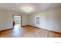 Light-filled living room showcasing gleaming hardwood floors and recessed lighting at 483 E State Highway 56, Berthoud, CO 80513