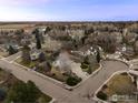 A nice aerial view of a neighborhood with mature trees and well-kept lawns at 7202 Snow Peak Ct, Niwot, CO 80503