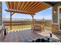 Inviting deck with a pergola, comfortable seating, and scenic views, ideal for outdoor dining and relaxation at 979 Stagecoach Dr, Lafayette, CO 80026