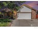 Charming home exterior with a well-maintained lawn, attached garage, and inviting front porch at 104 Plowshare Ln, Platteville, CO 80651