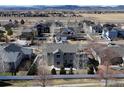 Backyard aerial view of a home in a suburban neighborhood with mountain views at 1108 Wilshire Dr, Berthoud, CO 80513