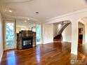 Bright living room with hardwood floors, a marble fireplace, and a staircase at 1114 4Th Ave, Longmont, CO 80501