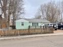 Charming single-story home featuring a fenced yard and mature trees in a quiet residential neighborhood at 144 E 5Th Ave, Longmont, CO 80504
