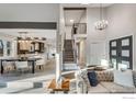 Open-concept living area with staircase, seamlessly connecting the kitchen, dining and living space at 2201 Juniper Ct, Boulder, CO 80304