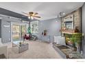 Relaxing living room with a stone fireplace, neutral color palette, and sliding door to outdoor deck at 2900 Purcell St, Brighton, CO 80601