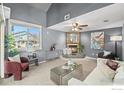 Cozy living room showcases a stone fireplace, high ceilings, and large windows for plenty of natural light at 2900 Purcell St, Brighton, CO 80601