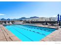 Stunning rooftop pool and spa boasting mountain views and ample seating for relaxation at 3701 Arapahoe Ave # 318, Boulder, CO 80303