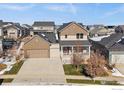 A beautiful two-story home features an attached two-car garage and well-maintained lawn at 4565 Colorado River Dr, Firestone, CO 80504