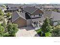 Charming two-story home featuring a cozy front porch and a spacious driveway at 4565 Colorado River Dr, Firestone, CO 80504