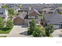 Beautiful two-story home with a well-maintained yard and an attached two-car garage at 4565 Colorado River Dr, Firestone, CO 80504