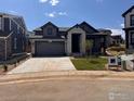Charming home with stone accents, a two-car garage, and a well-manicured lawn in a desirable neighborhood at 461 Muirfield Cir, Louisville, CO 80027