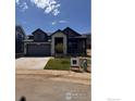 Charming home with stone accents, a two-car garage, and a well-manicured lawn in a desirable neighborhood at 461 Muirfield Cir, Louisville, CO 80027