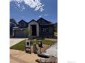 Charming home with stone accents, a two-car garage, and a well-manicured lawn in a desirable neighborhood at 461 Muirfield Cir, Louisville, CO 80027