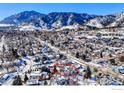 Scenic aerial view of the home surrounded by snow-covered neighborhood with mountain backdrop at 508 Valley View Dr, Boulder, CO 80304