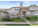 Charming home with stone facade, manicured landscaping, and a welcoming entrance at 8887 Tappy Toorie Cir, Highlands Ranch, CO 80129