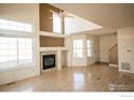 Spacious living room featuring a fireplace, lots of windows and hardwood floors at 930 Button Rock Dr # 102, Longmont, CO 80504