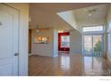 Bright living room with vaulted ceilings, hardwood floors, and sliding door at 930 Button Rock Dr # 102, Longmont, CO 80504