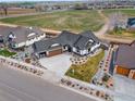 Stunning aerial view of home highlighting landscaping, three-car garage, and neighborhood at 1291 Swan Peter Dr, Berthoud, CO 80513