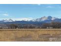 Distant view of snow capped mountains over a beautiful open landscape at 1503 Glacier Ave, Berthoud, CO 80513