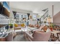 Bright living room with modern furnishings, large windows, and a cozy reading nook with plants and decor at 2272 Old Rail Way, Superior, CO 80027