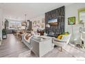 Stylish living room featuring a modern fireplace, comfortable seating, and an open layout connecting to the kitchen at 2272 Old Rail Way, Superior, CO 80027
