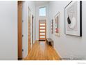 Bright hallway with wooden floors, modern doors, and a contemporary design aesthetic at 2286 Star Hill St, Longmont, CO 80503