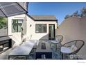 Modern patio featuring a fire pit, comfortable seating, stylish decor, and an umbrella for shade at 2434 Mapleton Ave, Boulder, CO 80304