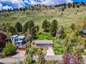 Beautiful home surrounded by mature trees and lush landscaping at the base of a mountain at 2975 3Rd St, Boulder, CO 80304