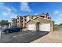 Apartment complex with attached two car garages, convenient parking, neutral colors, and manicured landscape at 3035 Blue Sky Cir # 10-207, Erie, CO 80516