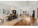 Spacious dining and living area featuring hardwood floors, ample natural light, and elegant furnishings at 3835 Norwood Ct, Boulder, CO 80304
