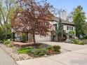 Attractive home with stone detailing, a two-car garage, mature trees, and landscaped flower beds at 3835 Norwood Ct, Boulder, CO 80304