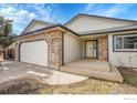 Attractive single-Gathering home with stone accents, a two-car garage, and a covered front porch at 465 Orchard Dr, Louisville, CO 80027