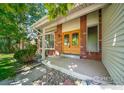 Charming front porch with brick and siding and a custom wood front door at 4672 Kirkwood Ct, Boulder, CO 80301