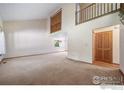 Bright living room featuring neutral carpet, lots of natural light, and stairs to second floor at 4672 Kirkwood Ct, Boulder, CO 80301