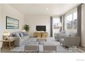 Bright living room with modern decor, including a gray sofa, armchairs, and a large window at 4743 Hatcher Dr, Brighton, CO 80601
