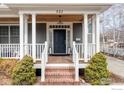 Inviting front porch with classic columns, brick stairs, and a wood ceiling at 521 Hawthorn Ave, Boulder, CO 80304